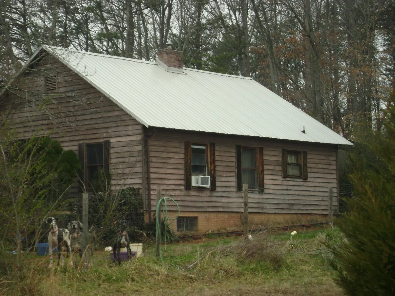 White metal roof on an old wood sided farmhouse, from a Metal Roof Installation job in Hamlet